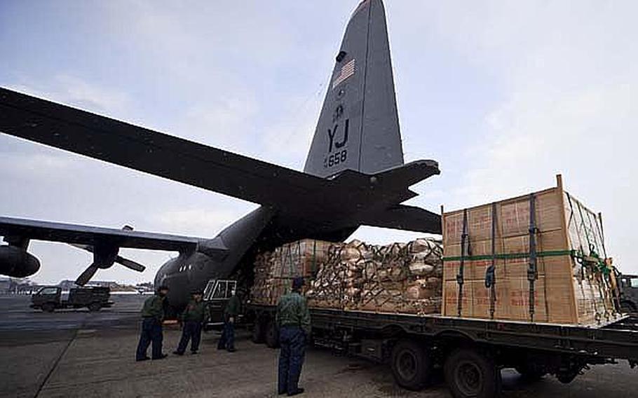 Japanese Air Self-Defense Force personnel at Chitose Air Base help load pallets of food and supplies onto C-130s from Yokota Air Base headed to Matsushima Air Base. Yokota was the headquarters for Operation Tomodachi, the U.S. military's humanitarian assistance operation to provide relief to victims of the quake.
 
