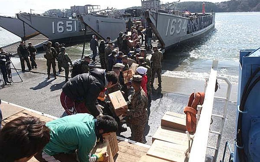 Relief supplies are unloaded Sunday onto Oshima Island, where elements of the USS Essex Amphibious Ready Group, the 31st Marine Expeditionary Unit and the Japan Self-Defense Force also brought the equipment necessary to restore power that had been off since Japan's March 11 earthquake and tsunami.