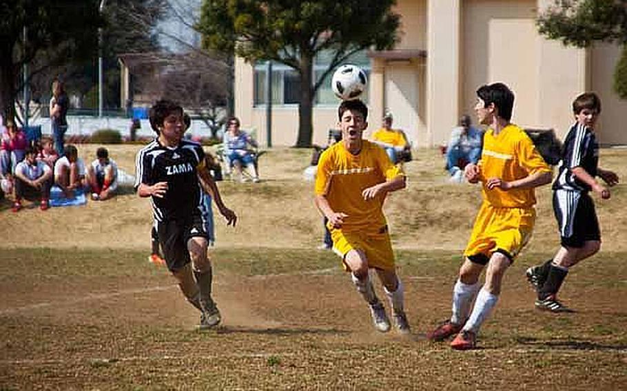 A Yokota High School student uses his head during a soccer match between Yokota High School and Zama American High School team on Saturday at Bonk Field. The young athletes came from schools throughout the Kanto region, appearing happy to take to the field to participate in Sports Day on the base.