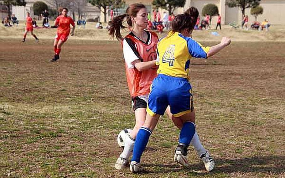 Competitors Yokota High School and a combined team of Zama American High/Nile C. Kinnick battle for the ball during a soccer match Saturday at Bonk Field at Yokota Air Base. The young athletes came from schools throughout the Kanto region to participate in Sports Day. The regularly scheduled sporting events for Defense Department schools' athletes in the Kanto Plain were cancelled following the March 11 earthquake.