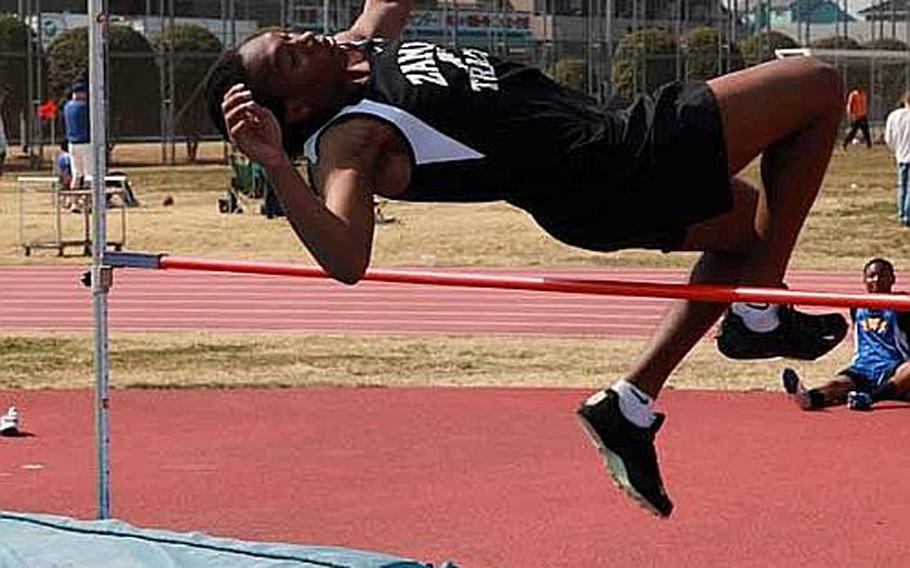 Ian Pope of Zama American High School leaps his way over the bar during a high jump event for Sports Day on  Saturday at Bonk Field at Yokota Air Base, Japan.