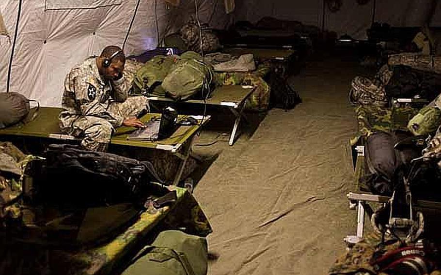 Sgt. Nickolas Jones, 26 from the 78th Signal Battalion watches a movie during some down time at the temporary U.S. military camp at Sendai Airport.