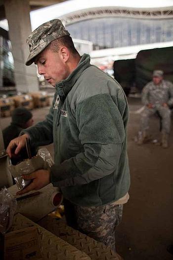 Spc. Dylan Norton, 21 from the Combat Sustainment and Support Battalion eats a Meals, Ready-to-Eat with fellow soldiers at the Sendai Airport in Sendai, Japan. The is base houses about 200 Marines and soldiers, out of Okinawa and camps Fuji and Zama as well as a few Airmen out of Hawaii.