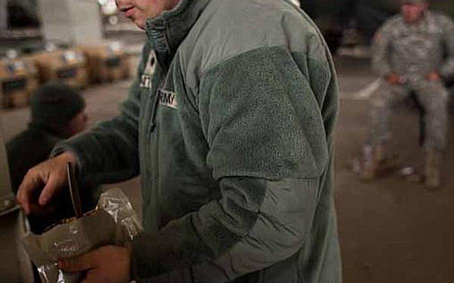Spc. Dylan Norton, 21 from the Combat Sustainment and Support Battalion eats a Meals, Ready-to-Eat with fellow soldiers at the Sendai Airport in Sendai, Japan. The is base houses about 200 Marines and soldiers, out of Okinawa and camps Fuji and Zama as well as a few Airmen out of Hawaii.