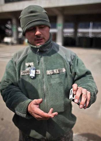 Sgt. James Harrison, 31, with the 35th Combat Sustainment Support Battalion, talks about the two dosimeters the Army and Air Force require him to wear at the temporary U.S. military camp set up at Sendai Airport in Sendai, Japan.