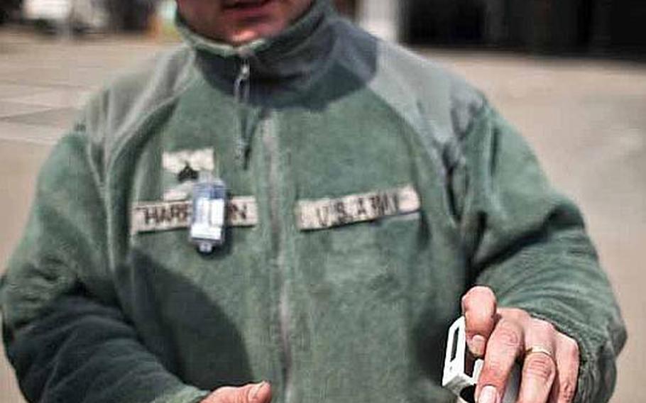Sgt. James Harrison, 31, with the 35th Combat Sustainment Support Battalion, talks about the two dosimeters the Army and Air Force require him to wear at the temporary U.S. military camp set up at Sendai Airport in Sendai, Japan.