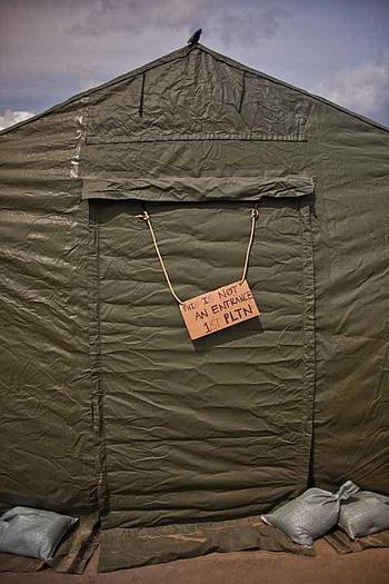A sign that reads, "This is not an entrance-1st Platoon," hangs outside the rear entrance to a tent at a temporary camp set up at Sendai Airport in Sendai, Japan. The base is home to about 200 Marines and soldiers, out of Okinawa and camps Fuji and Zama as well as a few Airmen out of Hawaii.