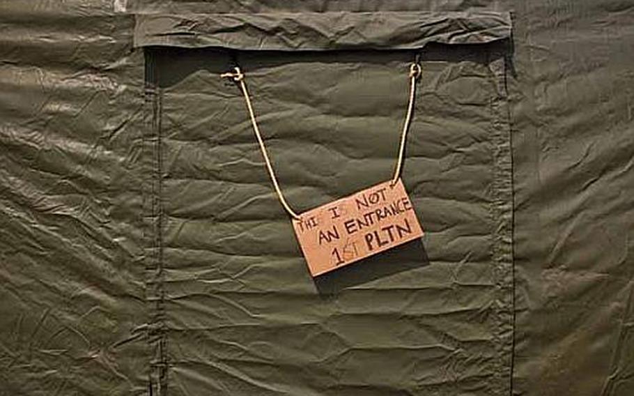 A sign that reads, "This is not an entrance-1st Platoon," hangs outside the rear entrance to a tent at a temporary camp set up at Sendai Airport in Sendai, Japan. The base is home to about 200 Marines and soldiers, out of Okinawa and camps Fuji and Zama as well as a few Airmen out of Hawaii.