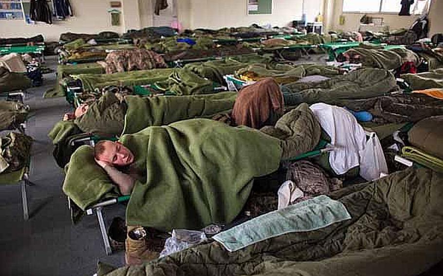 Marines, soldiers and troops from the Japan Self-Defense Force sleep in a male berthing at Camp Sendai, Japan.