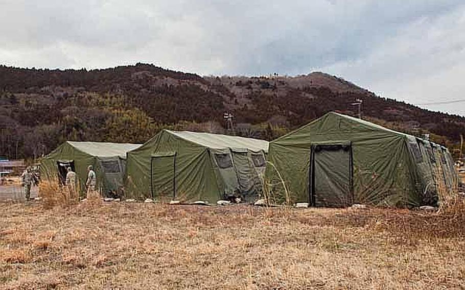 Soldiers begin to set up their new area base of operations on the grounds of the Ishinomaki General Sports Park, in Ishinomaki, Japan.