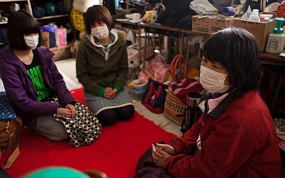 Yumi Nakajima, right, whose home was destroyed in the March 11 tsunami, sits with her sister and niece at the Kadonowaki Middle School shelter in Ishinomaki, Japan. Shelter officials have told its residents to clear out of the classrooms where they live by the beginning of the new school year on April 21.