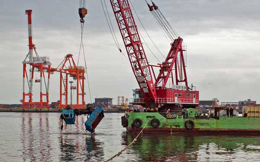 Salvage teams continued their work at Sendai Port despite the 7.1 magnitude aftershock that struck off the coast of Sendai, April 7.