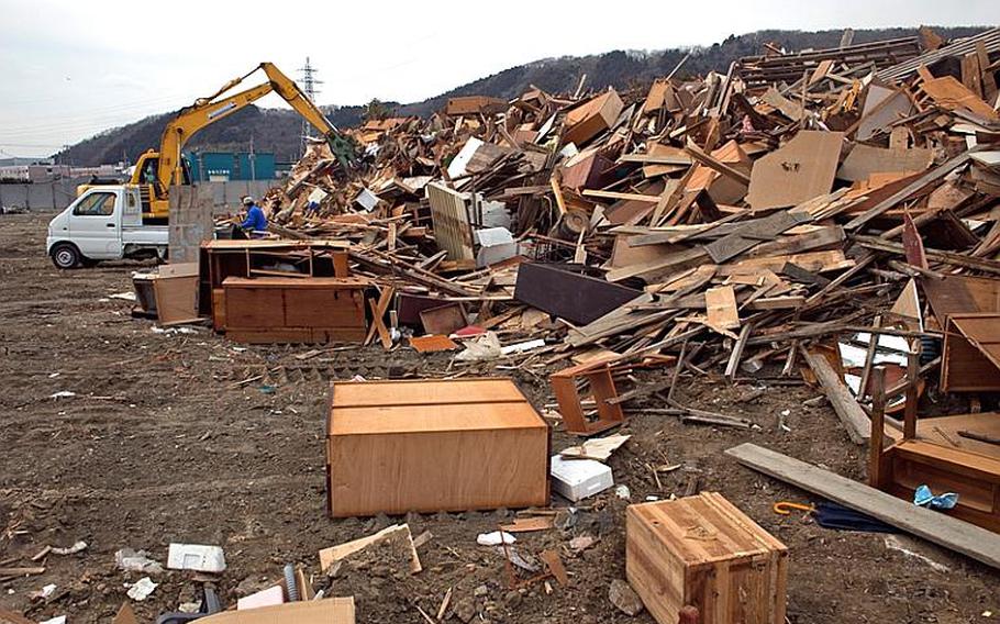 A pile of broken wood sit at one of two tsunami-related trash dump sites in Ishinomaki, Japan.