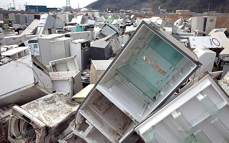 A pile of thousands of destroyed electrical appliances sit at one of two tsunami-related trash dump sites in Ishinomaki, Japan.