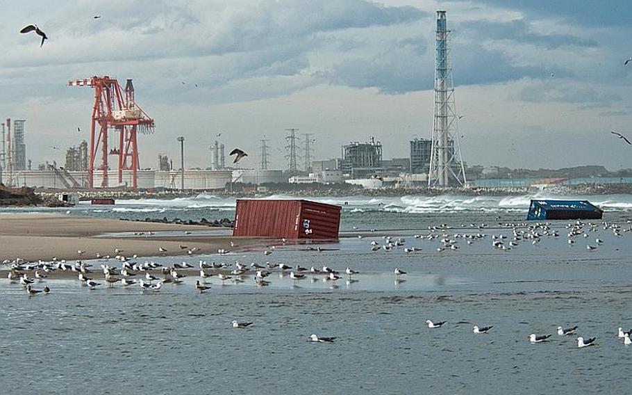 Shipping containers sit at Nagahama Beach in Sendai, Japan.