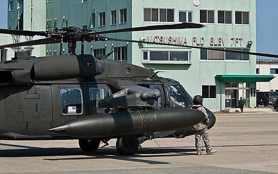 A U.S. Army UH-60 Black Hawk helicopter sits at Japan Self-Defense Force's Matsushima Air Base in Higashimatsushima, Japan. Two UH-60s from Camp Zama-based U.S. Army Aviation Detachment Japan, along with two fixed-wing aircraft from Naval Air Facility Atsugi, have transported personnel and supplies in support of relief efforts in the region since March 18.