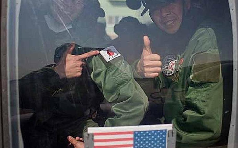 Japan Self-Defense Force troops sit inside a U.S. Army UH-60 Black Hawk helicopter at Matsushima Air Base in Higashimatsushima, Japan.