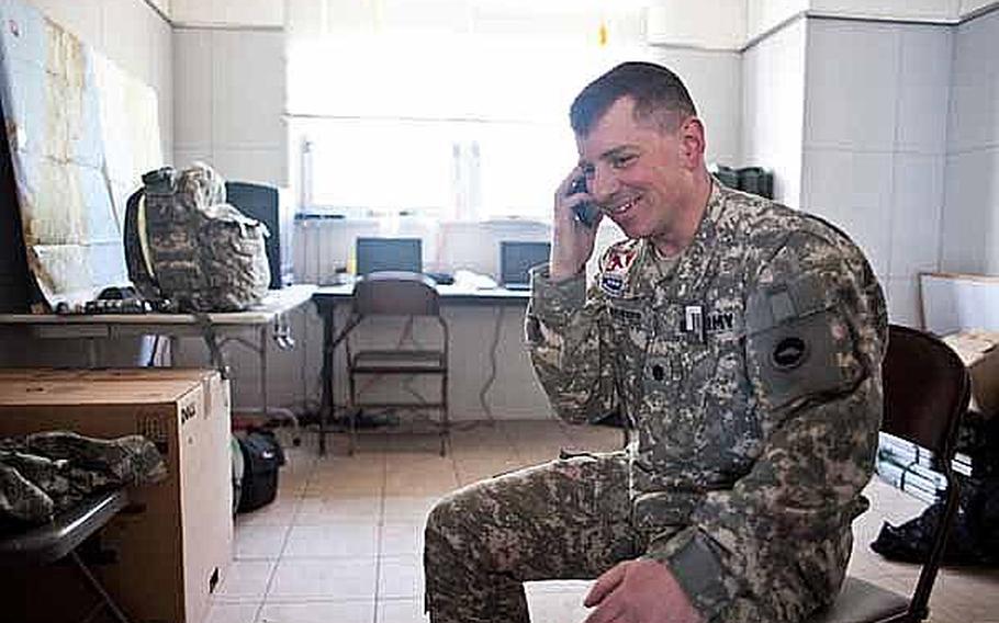 Lt. Col. Robert Brinson, commander of U.S. Army Aviation Detachment, Japan, talks on his phone prior to a mission to transport Army environmental health workers by helicopter at Matsushima Air Base in Higashimatsushima, Japan.Two UH-60s from the Camp Zama-based detachment, along with two fixed-wing aircraft from Naval Air Facility Atsug,i have transported personnel and supplies in support of relief efforts in the region since March 18.