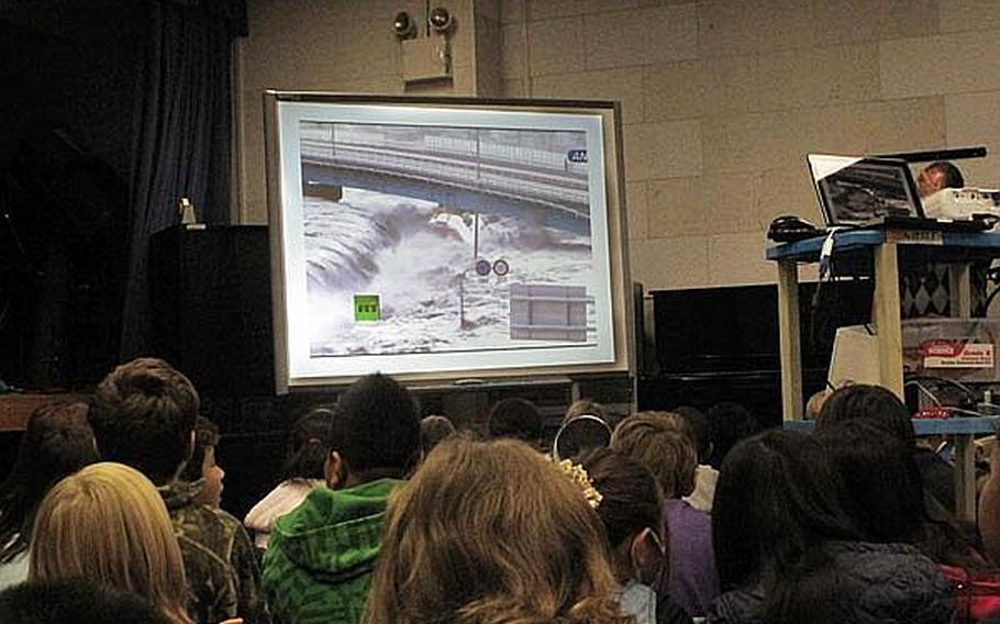 Fourth grade and fifth grade students at Yokosuka Naval Base's Sullivans School in Japan watch video footage of the March 11 tsunami as it overwhelms the nation's coastline. Educators at U.S. military base schools in Japan say they must walk a fine line by teaching students about the disaster, but not increasing their anxieties.