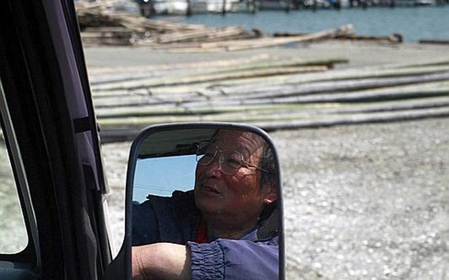 Fisherman Satoshi Nishimura, 63, who lost his boat in the tsunami, looks out over a harbor in Matsushima, Japan.