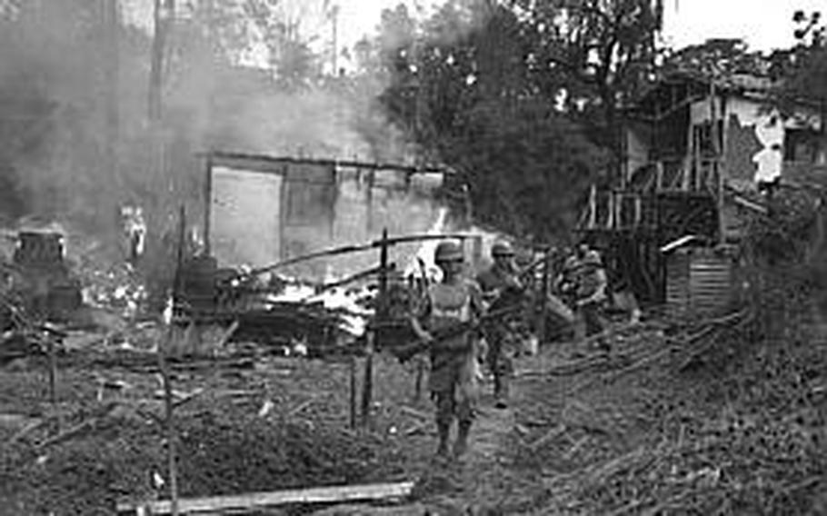 Leathernecks lead patrol between destroyed buildings in "mop-up" of Wolmi Island, gateway to Inchon.  September 15, 1950.