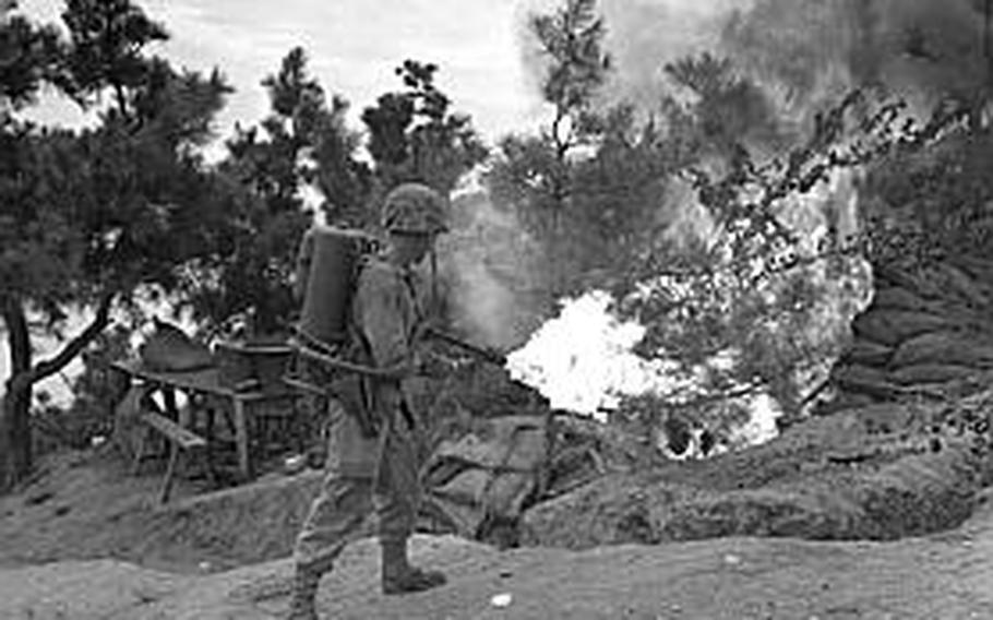 A U.S. Marine uses a flame thrower to burn out an enemy position on Wolmi Island, gateway to Inchon.