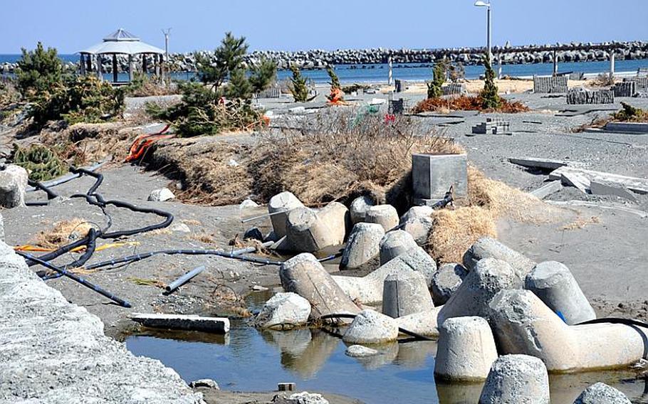 The road connecting Misawa City port and the swimming beach was washed out when a tsunami wave hit the area on March 11. The wave gutted buildings, beached boats and killed two.