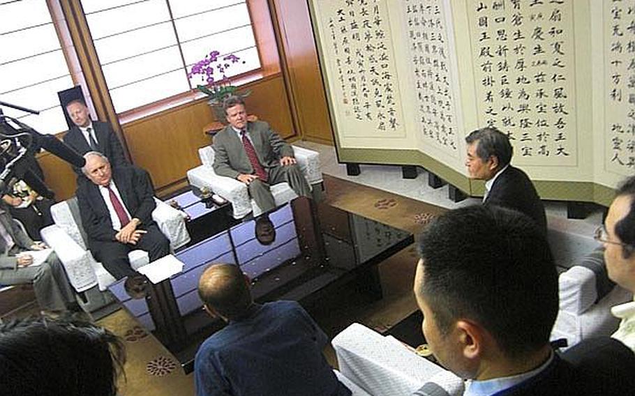 Sen. Carl Levin, D-Mich, left, and Sen. Jim Webb, D-Va., right, speak with Okinawa Gov. Hirokazu Nakaima, bottom center, during a meeting in Naha Wednesday about the Futenma air station relocation.