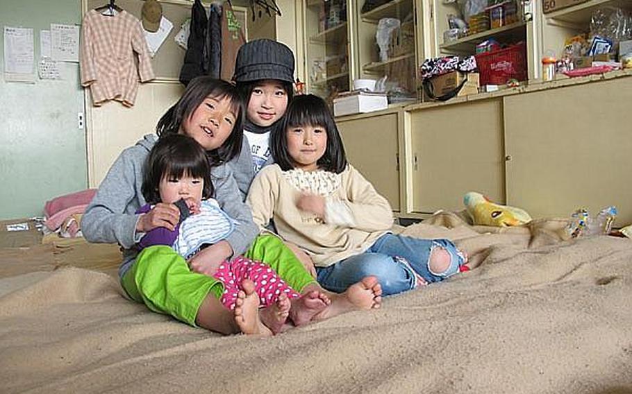 Ami Iimori, 8, second from left, and the other children pictured live in classrooms at Okaido Elementary School in Ishinomaki. Thousands were left homeless in the city following the March 11 tsunami in northeast Japan. Ami is one of 11 children who both live in and attend class at the school. Educators at the school say they will observe the children closely before discussing the disaster with them.