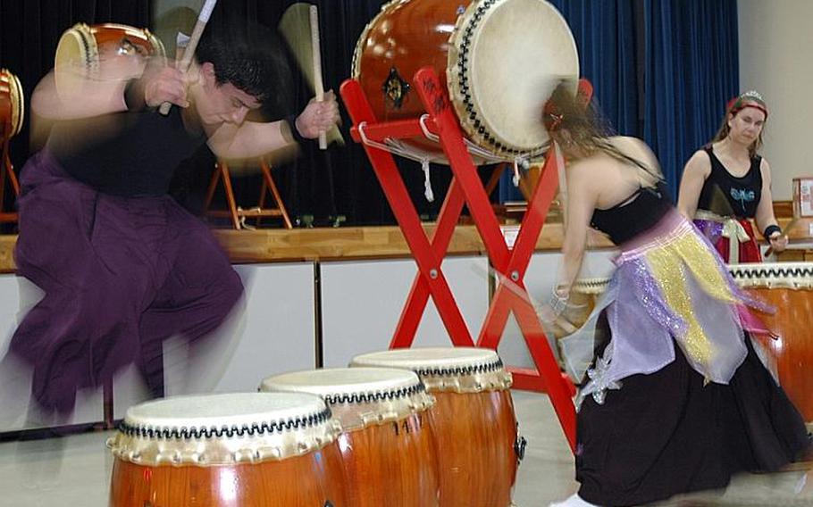 Matthew Bernal, left, leaps into the air during a Dragon-Eagle Taiko drum performance Saturday at Misawa Air Base, Japan.