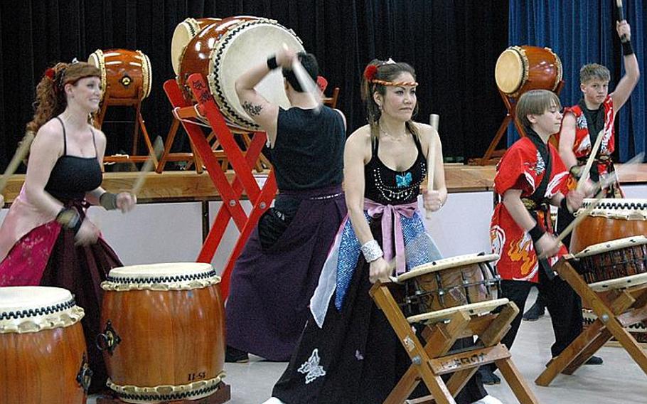 Kazuko Igarashi, center, leads the Dragon-Eagle Taiko drum team through a performance at Misawa Air Base, Japan, on Saturday.