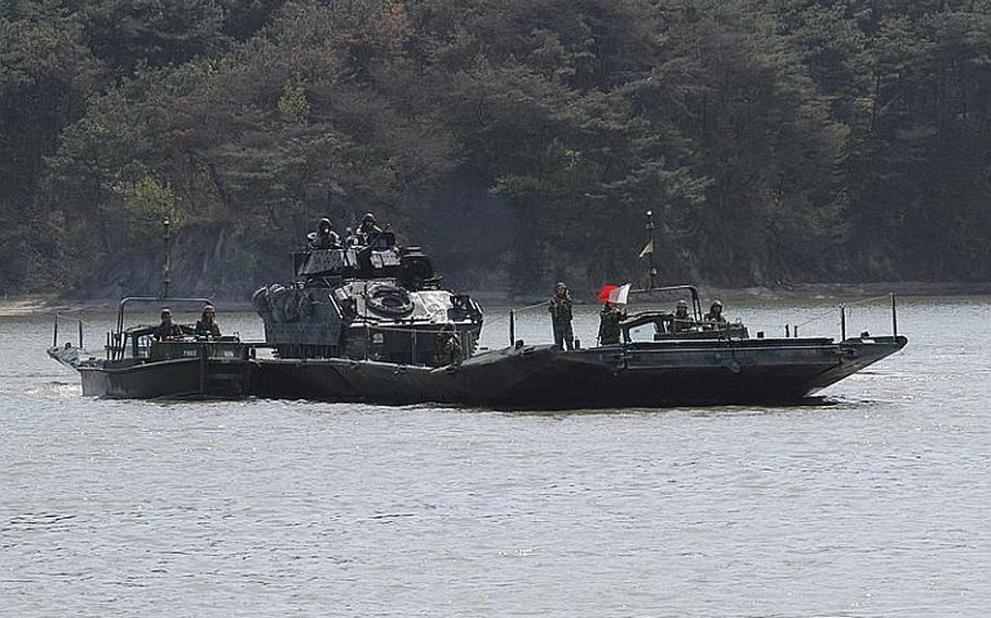 A Bradley is ferried toward land during a joint U.S.-South Korean military exercise Tuesday at a base 13 miles from the Demilitarized Zone. About 150 soldiers practiced how manpower and equipment would be moved across lakes, rivers and streams in the event hostilities ever resume on the Korean peninsula.