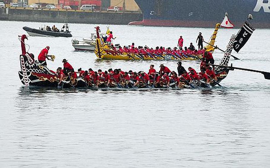 The female Single Marine Program dragon boat team races toward the finish line during the 37th annual Naha Hari dragon boat races held in Naha Port Thursday. They won their heat with a time of 5 minutes and 53 seconds - beating many male teams in the process.