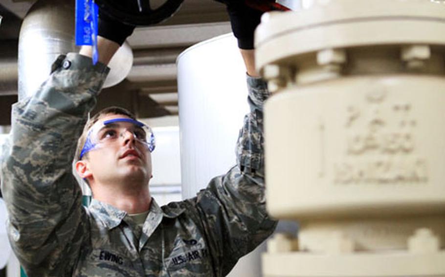 Airman 1st Class Matthew Ewing, 374th Civil Engineer Squadron, works on the chill water valve for an air conditioning unit to help with energy saving measures Friday on Yokota Air Base, Japan.