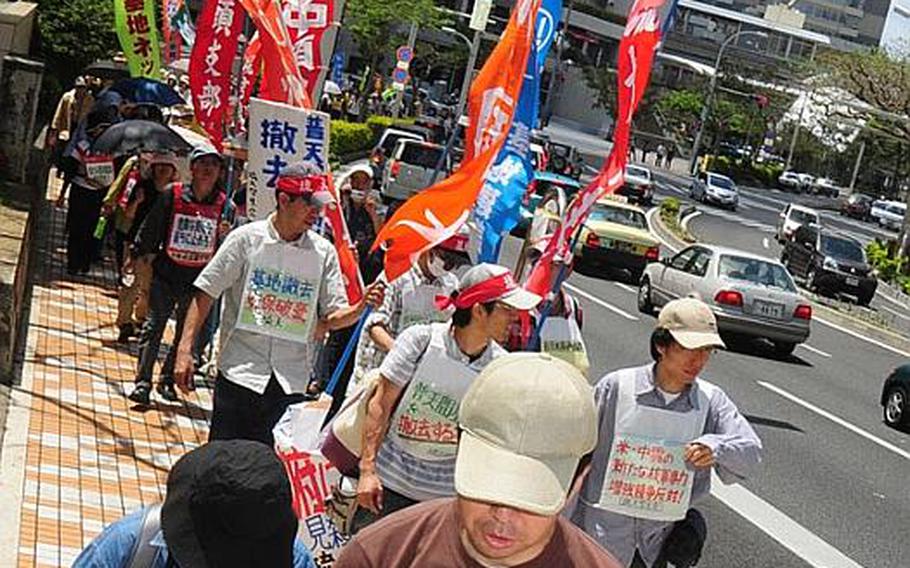 Protesters march toward the entrance of the Prefectural Government Office in Naha, Okinawa on Saturday, where Japanese Defense Minister Toshimi Kitazawa was to speak with Okinawa Governor Hirokazu Nakaima about the future plans for Marine Corps Air Station Futenma.