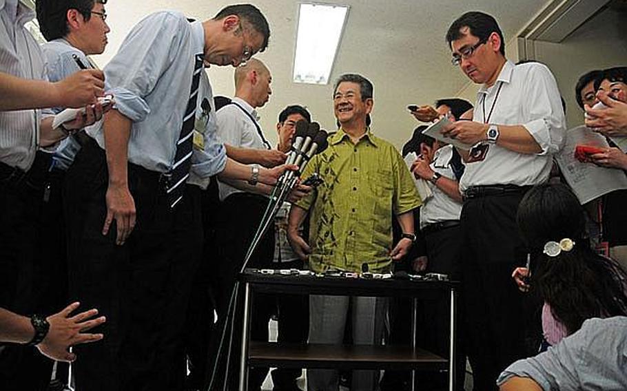 Japanese Defense Minister Toshimi Kitazawa answers questions from Okinawa media after a 25-minute meeting with Okinawa Governor Hirokazu Nakaima in Naha on Saturday. Kitazawa was seeking support for moving Futenma Marine Corps air operations to Camp Schwab.