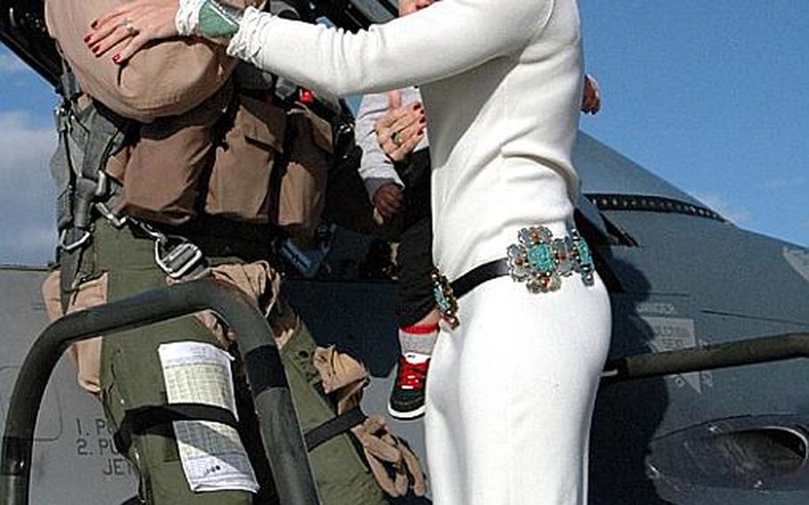 Natalee Kotowski holds 10-month-old Jackson as she welcomes her husband, Capt. Scott Kotowski, back to Misawa Air Base, Japan, on Friday. Kotowski and other members of the 13th Fighter Squadron returned Friday after a 7-and-a-half-month deployment to Joint Base Balad, Iraq.