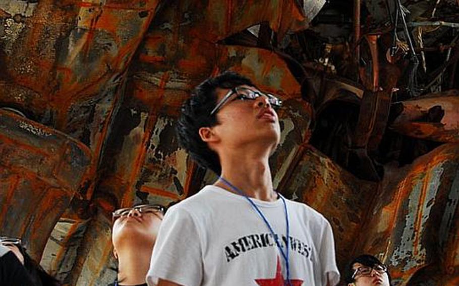Participants in USFK's Good Neighbor English Camp look Wednesday at the wreckage of the Cheonan, the South Korean ship hit last year by a North Korean torpedo. Sixty-six South Korean teenagers participated in the week-long camp.