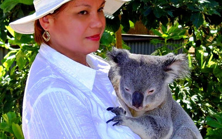 Quintana holds a koala. Her frequent trips around the world often inspire her work.