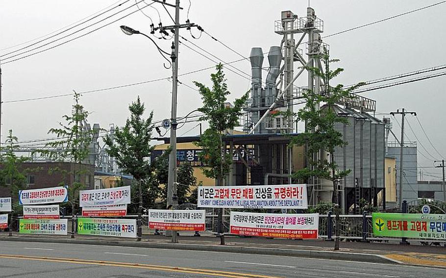 Approximately three dozen signs criticizing the U.S. hang across the street from the main entrance of Camp Carroll. The signs, posted by activist groups and a farmer's cooperative, demand that the U.S. government and U.S. military quickly investigate and apologize for its alleged burial of Agent Orange at the base in the late 1970s, conduct environmental surveys at all U.S. bases in South Korea, and provide compensation for environmental damage.