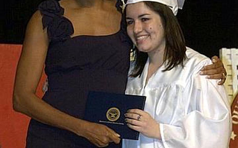 First lady Michelle Obama chats with a 2011 graduate of Quantico Middle/High School on Marine Corps Base Quantico, Va., June 3, 2011. The first lady gave the commencement address to the 36 graduates, including nine from Japan who relocated after the earthquake and tsunami earlier this year.