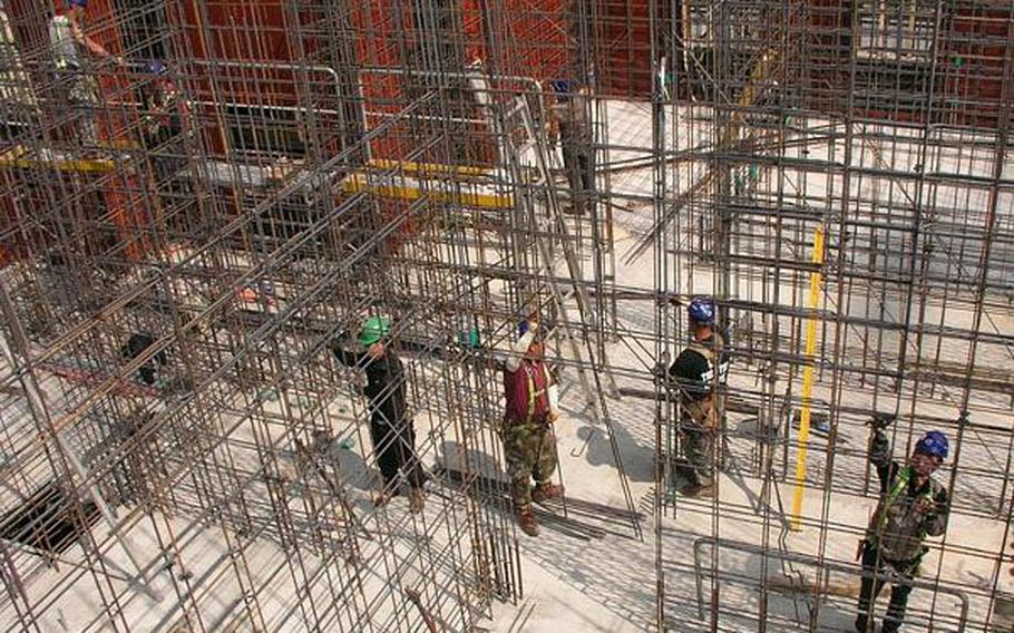 Builders work on the construction of six eight-story barracks on land acquired for Camp Humphreys' expansion in this photo from April 2009. 