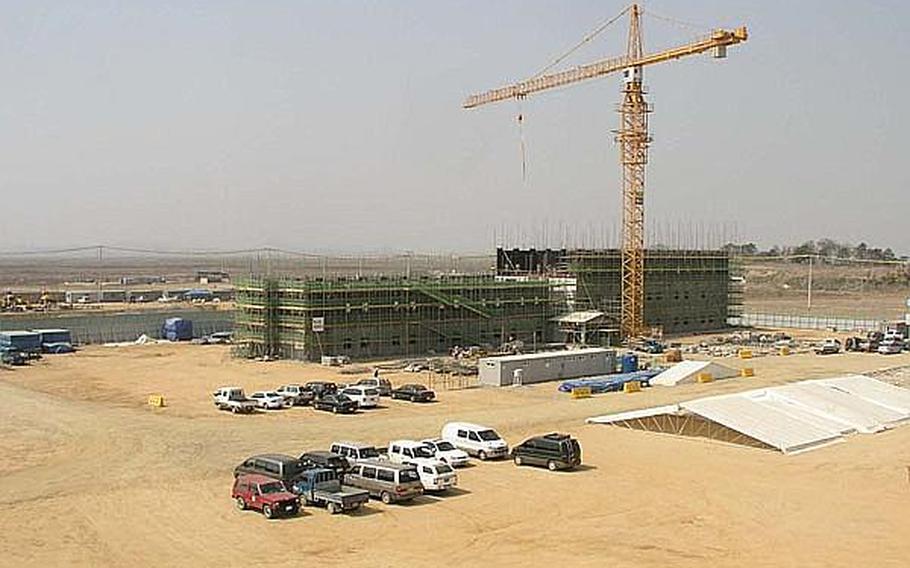 Work moves forward on construction of six eight-story barracks on land acquired for Camp Humphreys' expansion in this photo from April 2009. 