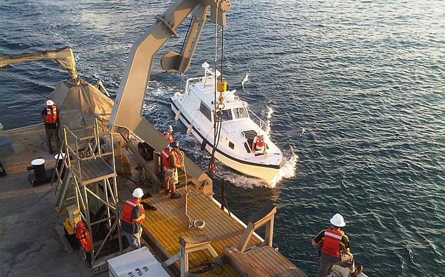 Crewmembers from the USNS Bowditch prepare a hydrographic survey launch during a recent mission off the coast of Vietnam to find underwater crash sites stemming from the Vietnam War. The U.S. Joint POW/MIA Accounting Command will use sonar data from the mission to search for the remains of fallen servicemembers.