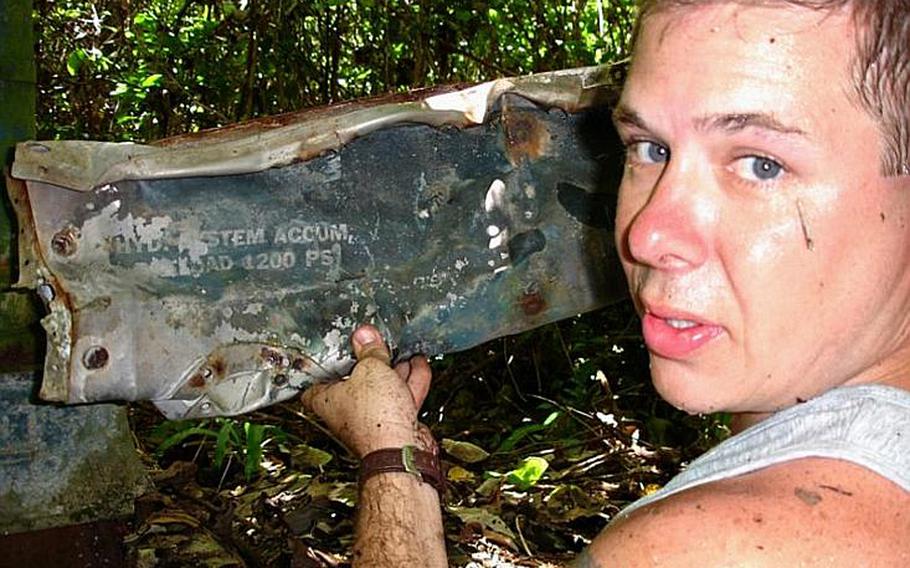 Pat Ranfranz  shows off a piece of wreckage from an old U.S. Navy FSF shipboard fighter plane he discovered on  Yap Island during his search in October of 2006 for the crash site of his uncle&#39;s long lost  B-24J bomber.