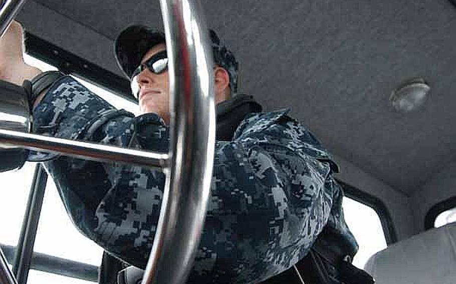 Petty Officer 2nd Class Ryan Blazer is at the helm on a mid-June patrol of the harbor near Sasebo Naval Base, Japan.