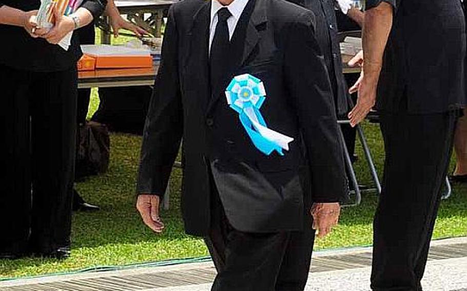 Takeo Nishioka, Speaker of the House of Councilors walks to his chair Thursday for the commencement of the Battle of Okinawa memorial service at Peace Prayer Park in Itoman.
