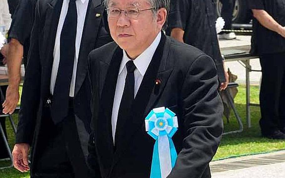 Takahiro Yokomichi, Speaker of the House of Representatives walks to his chair for the commencement of the Battle of Okinawa memorial service at Peace Prayer Park in Itoman.