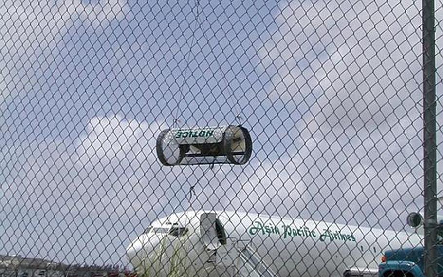 A brown tree snake trap hangs on the fence at Guam&#39;s international airport.