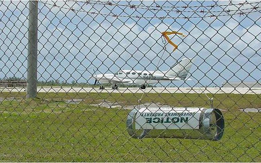 A brown tree snake trap hangs along the fence at Guam&#39;s international airport.